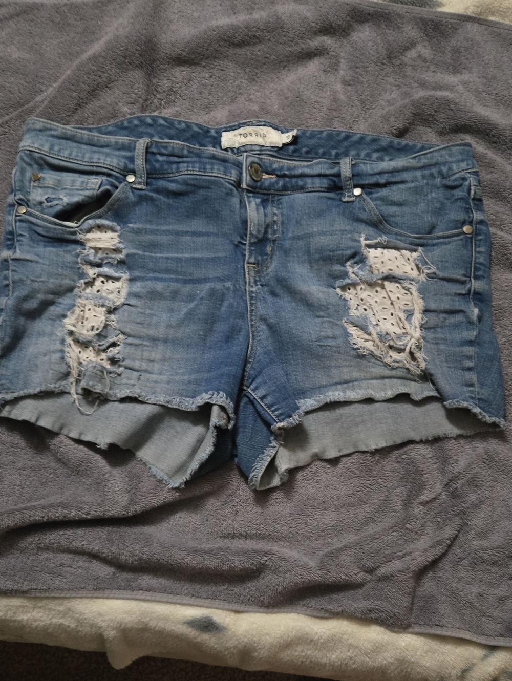 torrid Light Blue Distressed Denim Cutoff Shorts with Eyelet Underlay